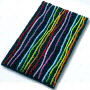 multi color novelty bath rug with fun colored stripes running over a solid background of either black, white, berry, navy or turquoise